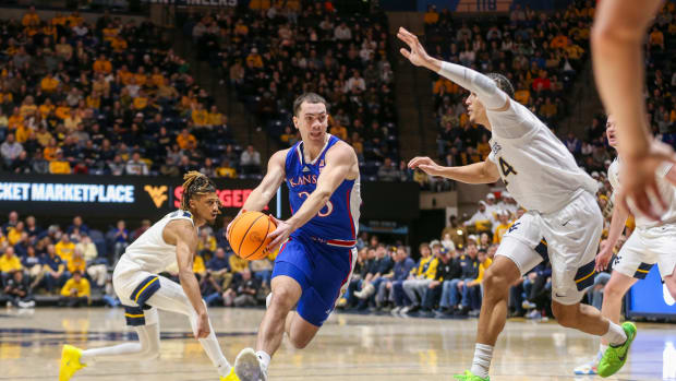 Jan 20, 2024; Morgantown, West Virginia, USA; Kansas Jayhawks guard Nicolas Timberlake (25) drives down the lane against West Virginia Mountaineers forward Patrick Suemnick (24) during the first half at WVU Coliseum. 